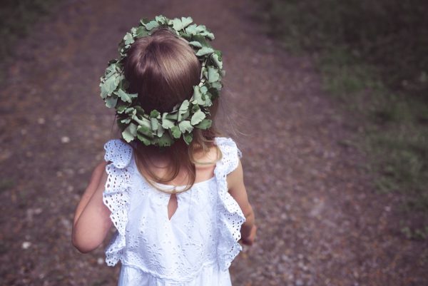 girl in white tank dress with green leaf crown