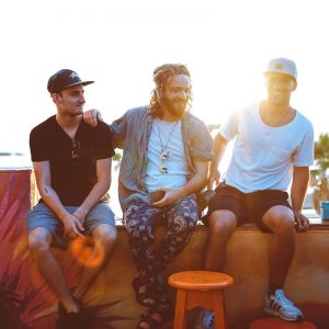 three man sitting on gray surface