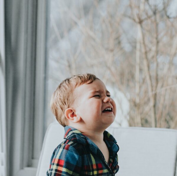 boy sitting near glass wall
