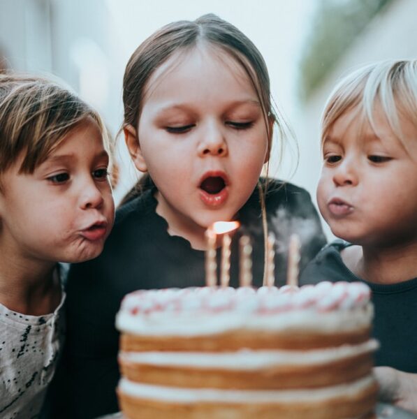 boy and girl blowing candles