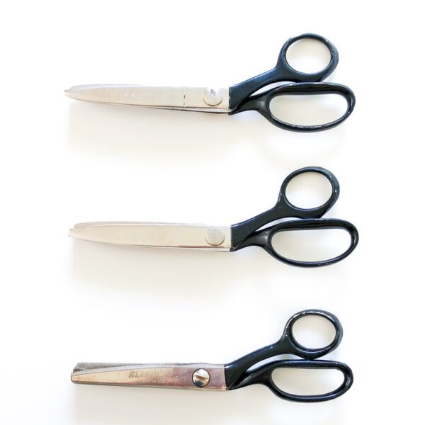 black handled scissors beside brown wooden handle knife