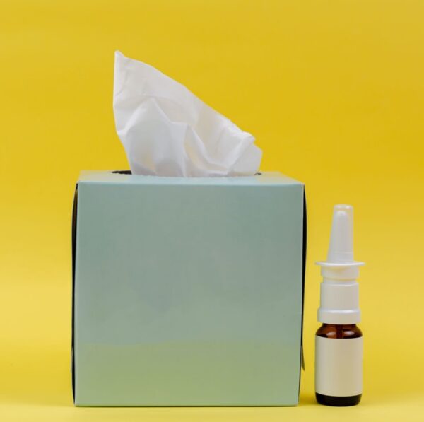 white and brown bottle beside white tissue box