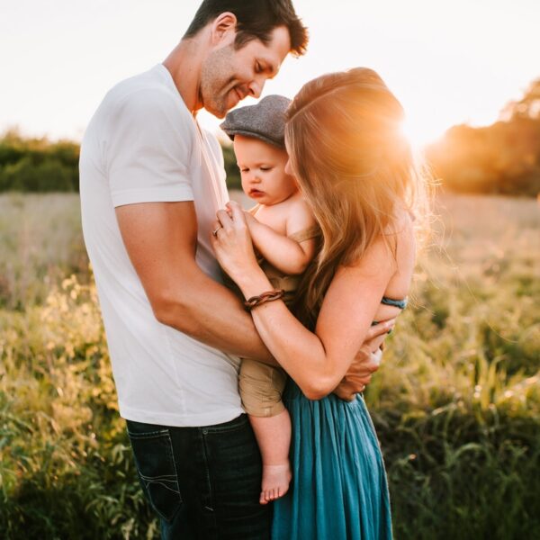family photo on green grass during golden hour