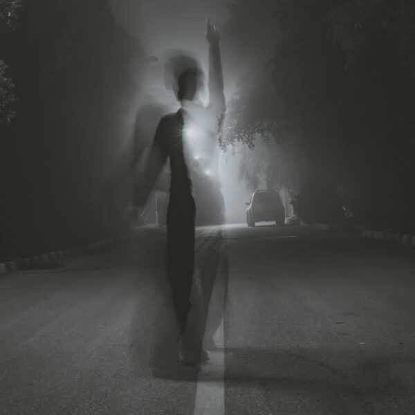 man standing at middle of road