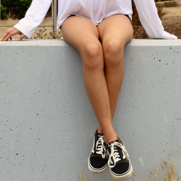 woman wearing black Vans Old Skool shoes