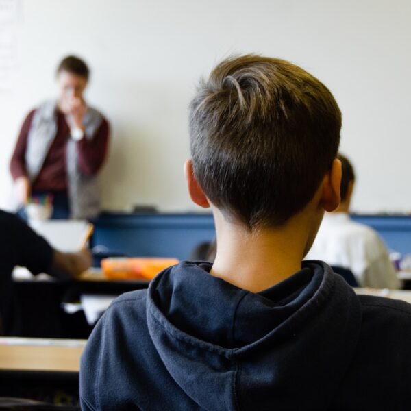 boy in black hoodie sitting on chair