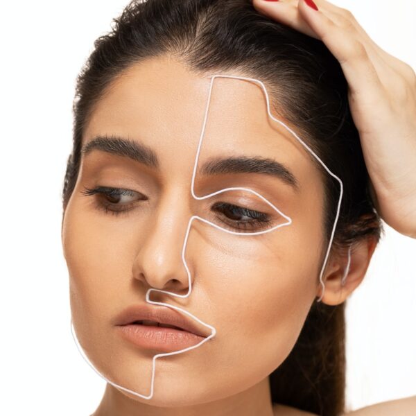 woman with brown hair and wearing silver necklace