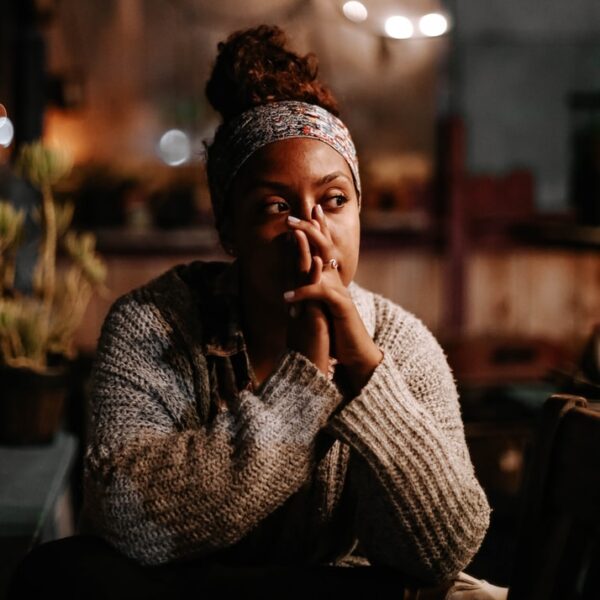 man in black and white sweater sitting on chair