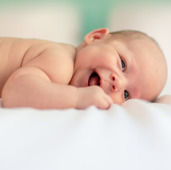 baby lying on fabric cloth