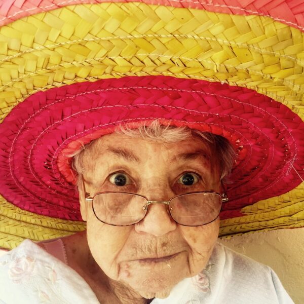 woman using eyeglasses and wearing hat