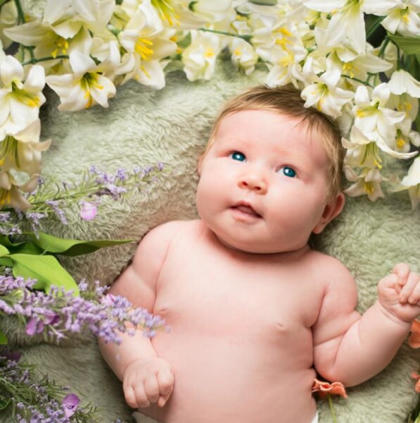baby on green sleeper with flowers