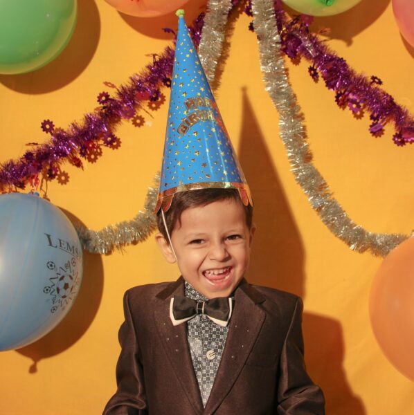 boy in black suit jacket smiling