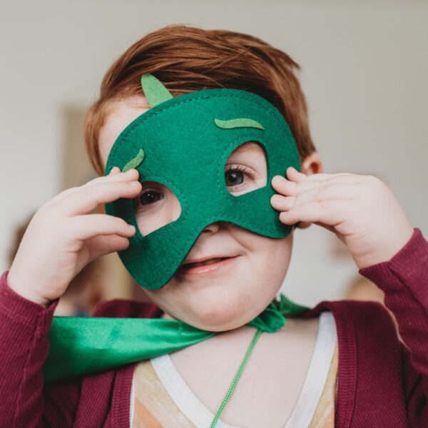 boy holding green mask