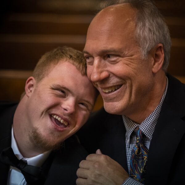 two man smiling on focus photography