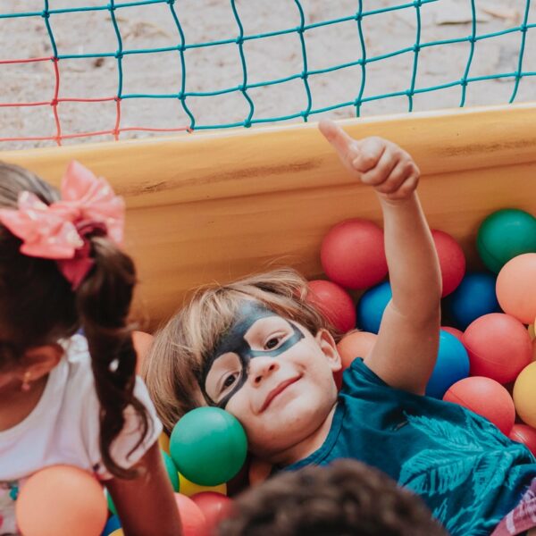 girl in blue shirt lying on yellow inflatable pool