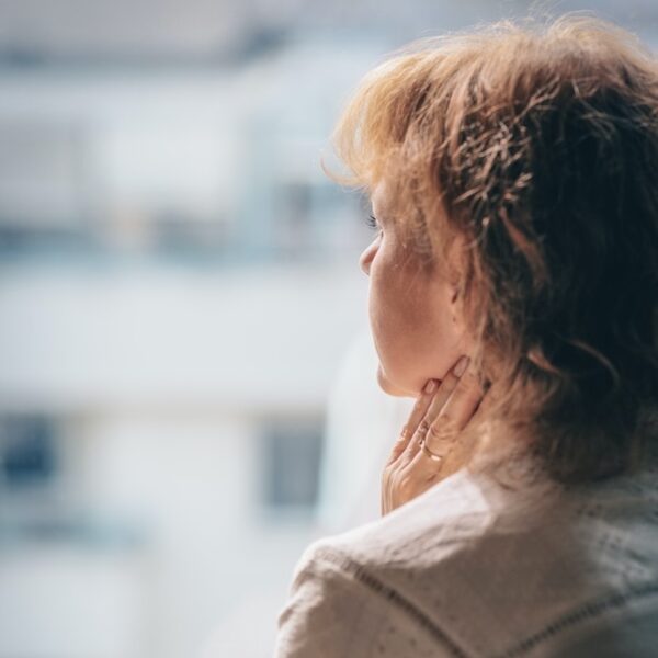 woman in white shirt looking down