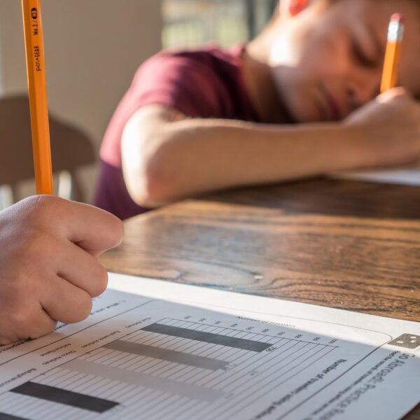 person writing on white paper