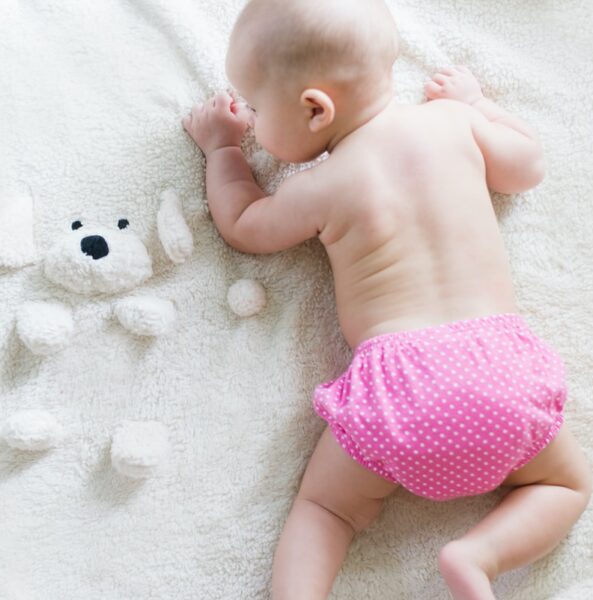 baby crawling on bed