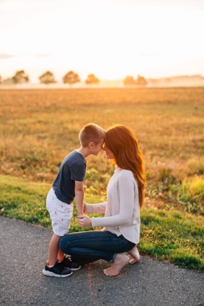 man and woman kissing on road during daytime