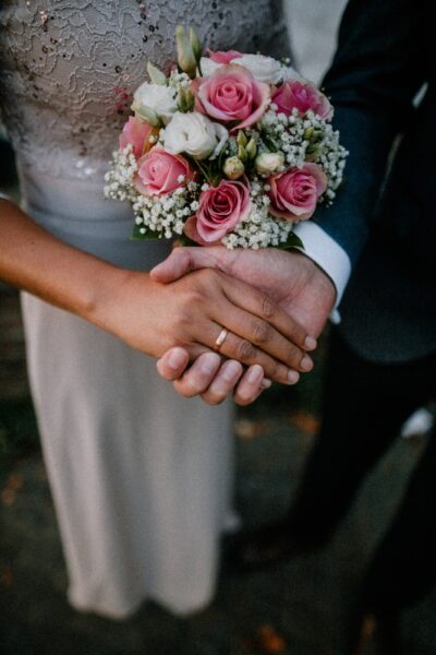 man and woman standing while holding hands