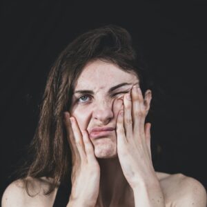 woman covering her face with her hand