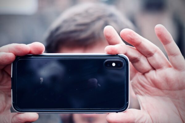 man holding space gray iPhone X