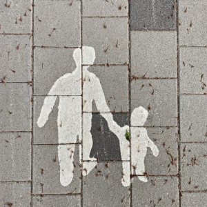 2 person walking on gray concrete pavement